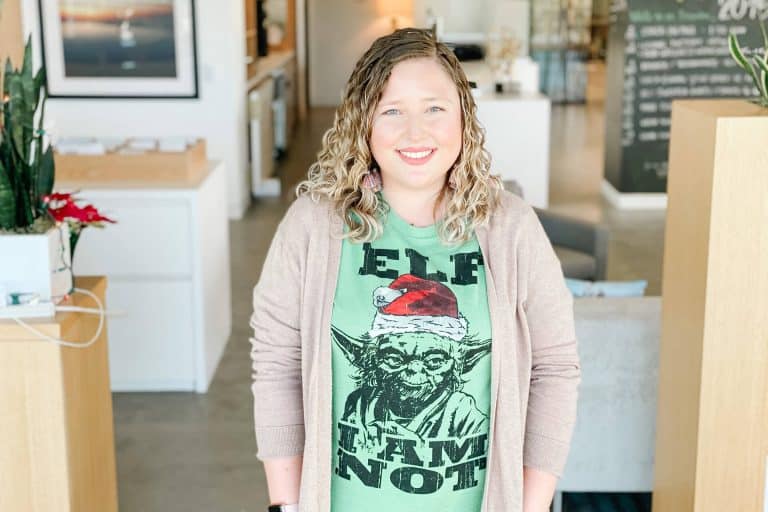 Female stands in office space and smiles - Steph Beckett for Meet The Team